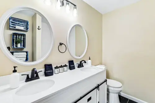 Private modern bathroom with standing shower and double sink